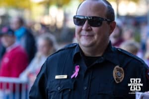 Lincoln police officer wearing a pink ribbon for cancer awareness during a college football game between Nebraska and Minnesota on Friday, October 17, 2025, in Minneapolis, Minnesota. Photo by John S. Peterson.