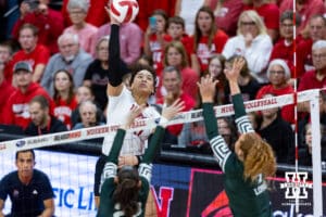 Nebraska Cornhusker outside hitter Teraya Sigler (11) spikes the ball against Michigan State Spartan middle blocker Carmen Waye (22) and setter Malayah Long (7) in the first set during a college volleyball match on Saturday, October 25, 2025, in Lincoln, Nebraska. Photo by John S. Peterson.