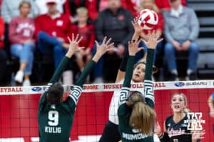 Nebraska Cornhusker outside hitter Harper Murray (27) spikes the ball against Michigan State Spartan middle blocker Zuzanna Kulig (9) and outside hitter Bianca Mumcular (3) during a college volleyball match on Saturday, October 25, 2025, in Lincoln, Nebraska. Photo by John S. Peterson.
