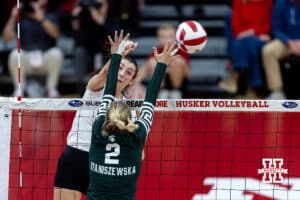 Nebraska Cornhusker opposite Virginia Adriano (9) spikes the ball against Michigan State Spartan outside hitter Karolina Staniszewska (2) in the first set during a college volleyball match on Saturday, October 25, 2025, in Lincoln, Nebraska. Photo by John S. Peterson.