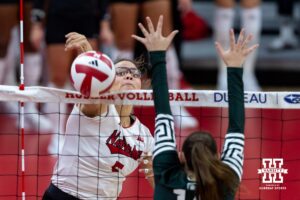 Nebraska Cornhusker middle blocker Rebekah Allick (5) hits the ball down the line against Michigan State Spartan outside hitter Taylah Holdem (14) in the second set during a college volleyball match on Saturday, October 25, 2025, in Lincoln, Nebraska. Photo by John S. Peterson.