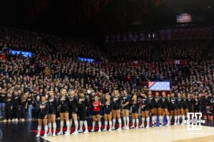 Nebraska Cornhuskers line up for the National Anthem against the Penn State Nittany Lions during the blackout volleyball match on Friday, Nov. 28, 2025, in Lincoln, Nebraska. Photo by John S. Peterson.