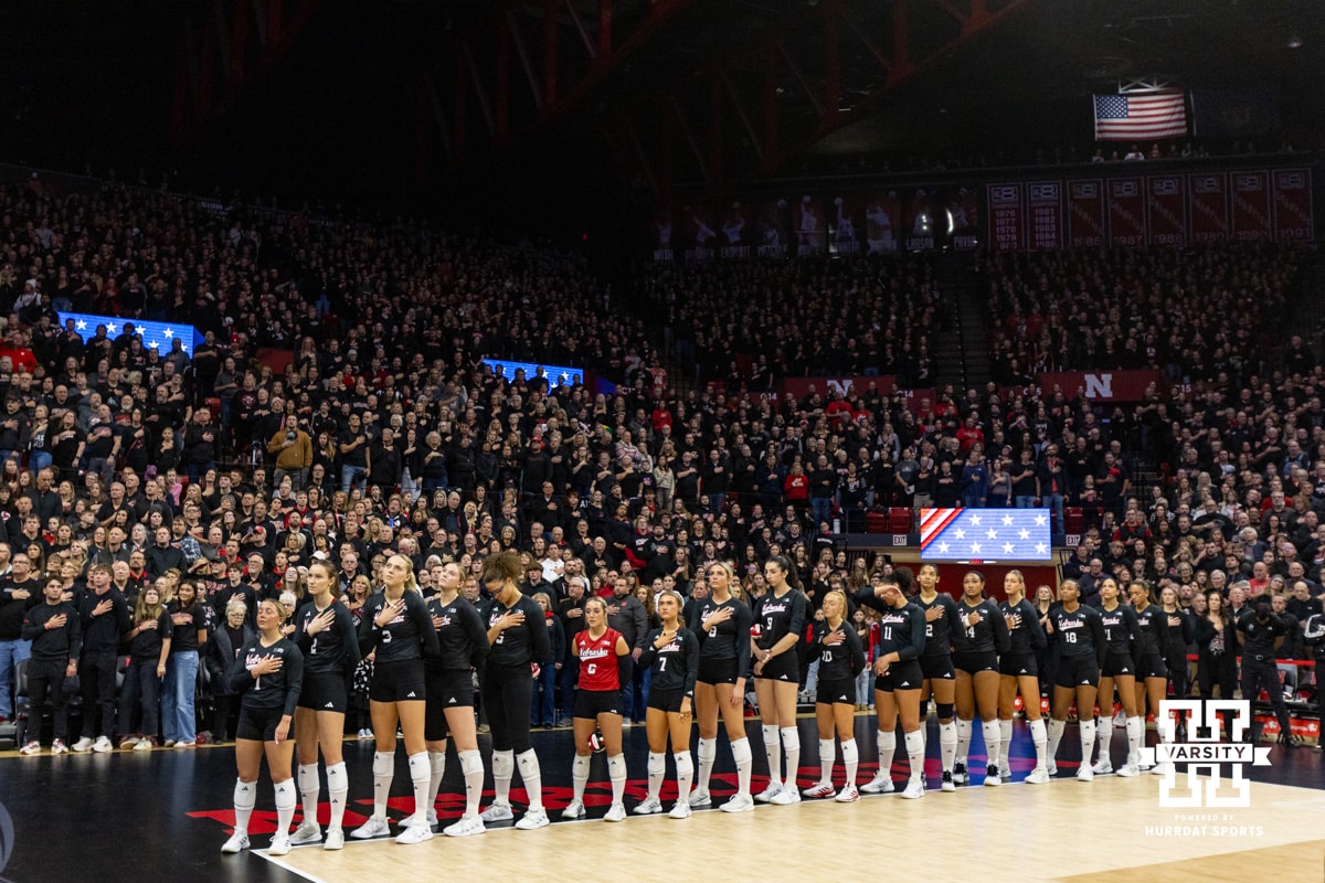 Nebraska Cornhuskers line up for the National Anthem against the Penn State Nittany Lions during the blackout volleyball match on Friday, Nov. 28, 2025, in Lincoln, Nebraska. Photo by John S. Peterson.