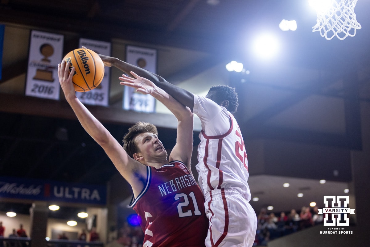 Nebraska Cornhusker forward Pryce Sandfort (21) makes a lay up against Oklahoma Sooner forward Kuol Atak (22) in the first half during a college men’s basketball game on Saturday, Nov 15, 2025, in Sioux Falls, South Dakota. Photo by John S. Peterson.