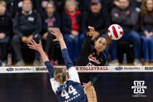 Nebraska Cornhusker outside hitter Harper Murray (27) spieks the ball against Penn State Nittany Lion middle blocker Maggie Mendelson (44) in the first set during a volleyball match on Friday, Nov. 28, 2025, in Lincoln, Nebraska. Photo by John S. Peterson.