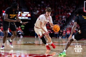 Nebraska Cornhusker forward Braden Frager (5) drives to the basket against Winthrop Eagle center Edward Nnamoko (23) and guard Daylen Berry (7) in the first half during a college basketball game on Tuesday, Nov. 25, 2025, in Lincoln, Nebraska. Photo by John S. Peterson.