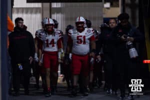 Nebraska Cornhusker quarterback TJ Lateef (14) and Justin Evans lead the huskers out for warm-ups during a college football game on Saturday, Nov. 22, 2025, in State College, PA. Photo by John S. Peterson.
