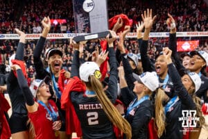 Nebraska Cornhusker setter Bergen Reilly (2) lifts the Big Ten Championship trophy over head celebrating their undefeated season after the volleyball match against the Penn State Nittany Lions on Friday, Nov. 28, 2025, in Lincoln, Nebraska. Photo by John S. Peterson.