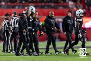 Nebraska Cornhusker quarterback Dylan Raiola (15) is helped off the field by Matt Rhule and a trainer in the third quarter against the Southern California Trojans during a college football game on Saturday, November 1, 2025, in Lincoln, Nebraska. Photo by John S. Peterson.