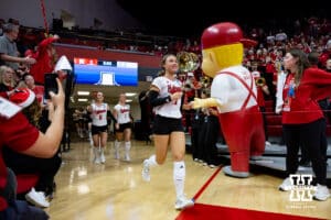 Nebraska Cornhusker defensive specialist Maisie Boesiger (7) leads the Huskers out to the court to take on the LIU Sharks during the first round of NCAA volleyball tournament on Friday, Dec. 5, 2025, in Lincoln, Nebraska. Photo by John S. Peterson.