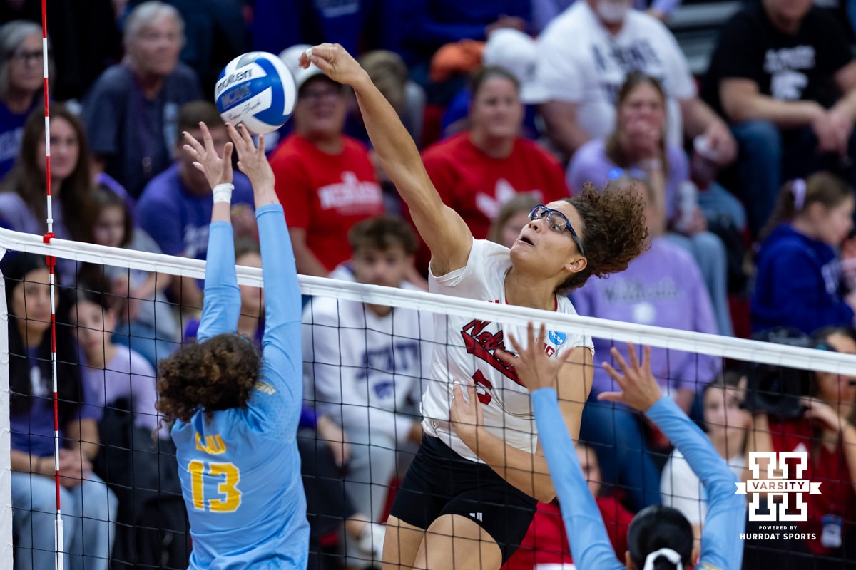 Nebraska Cornhusker middle blocker Rebekah Allick (5) spikes the ball against LIU Shark outside hitter Bella Correia (13) during the first round of the NCAA volleyball tournament on Friday, Dec. 5, 2025, in Lincoln, Nebraska. Photo by John S. Peterson.