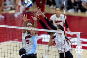 Nebraska Cornhusker middle blocker Rebekah Allick (5) and outside hitter Taylor Landfair (12) jump to block the ball against the LIU Sharks in the first set during the first round of the NCAA volleyball tournament on Friday, Dec. 5, 2025, in Lincoln, Nebraska. Photo by John S. Peterson.