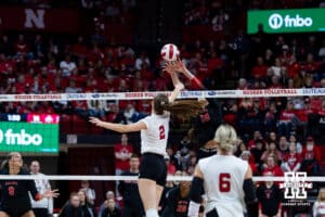 Nebraska Cornhusker setter Bergen Reilly (2) tips the ball over Ohio State Buckeye middle blocker Kaia Castle (19) during a volleyball match on Saturday, Nov. 29, 2025, in Lincoln, Nebraska. Photo by John S. Peterson.