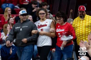 Nebraska Cornhusker middle blocker Rebekah Allick (5) escorted by her parents for senior day after win over Ohio State Buckeyes on Saturday, Nov. 29, 2025, in Lincoln, Nebraska. Photo by John S. Peterson.