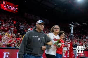 Nebraska Cornhusker middle blocker Rebekah Allick (5) escorted by her parents for senior day after win over Ohio State Buckeyes on Saturday, Nov. 29, 2025, in Lincoln, Nebraska. Photo by John S. Peterson.